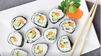 Ten pieces of sushi displayed on a white plate.